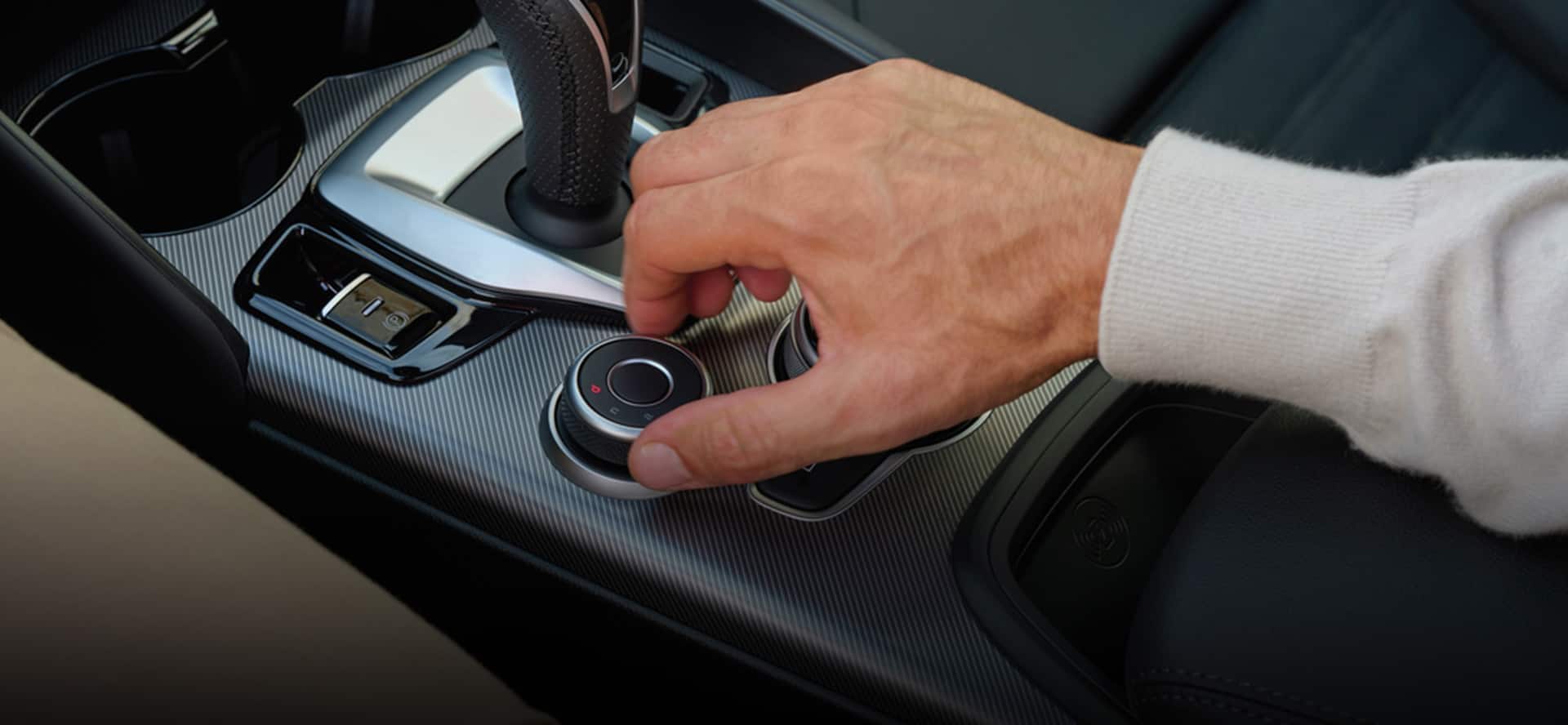 Driver adjusting the 2026 Alfa Romeo Giulia's DNA Drive Mode Selector, including the Advanced Efficiency setting