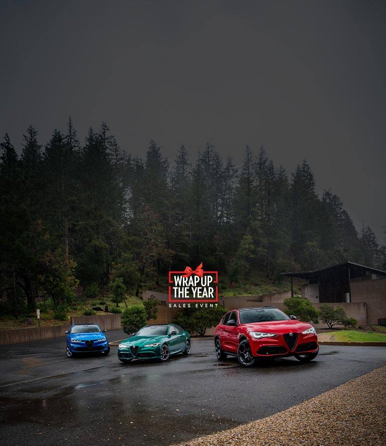 A red 2026 Alfa Romeo Tonale Sport Speciale model parked in a courtyard with a woman walking away from the vehicle