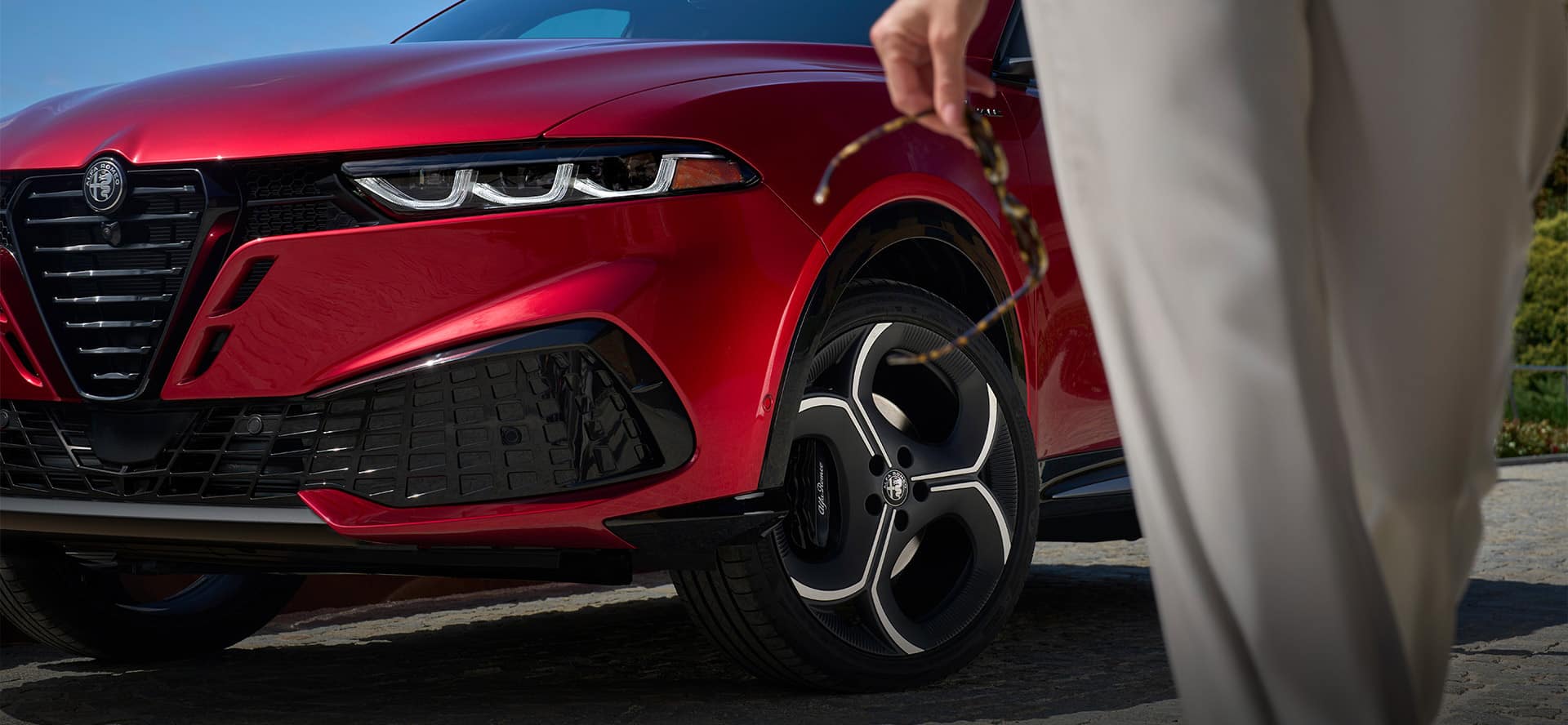 2026 Alfa Romeo Tonale front wheel and grille detail showing standard Q4 all-wheel drive styling