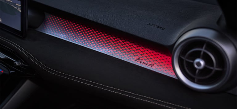 Red ambient lighting that runs across the dashboard of the 2026 Alfa Romeo Tonale Sport Speciale.