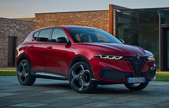 A passenger-side front angle of a red 2026 Alfa Romeo Tonale Sport Speciale.