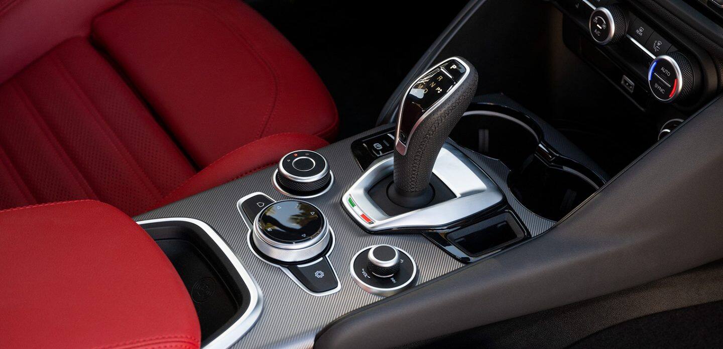Display The center stack controls in the 2023 Alfa Romeo Giulia, including the gear shift and DNA Drive Mode selector.
