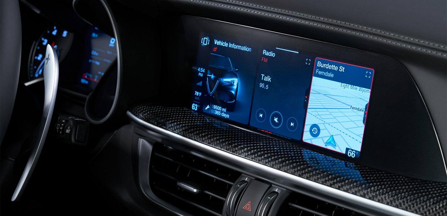 Display A close-up of the Uconnect toucscreen in the 2023 Alfa Romeo Stelvio Quadrifoglio, showing vehicle information, radio settings, and navigation.