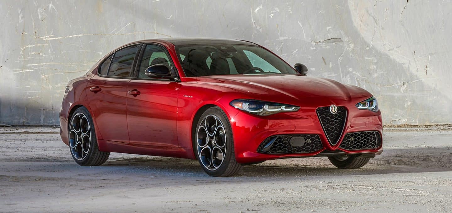 Display An angled front passenger-side profile of a red 2024 Alfa Romeo Giulia.