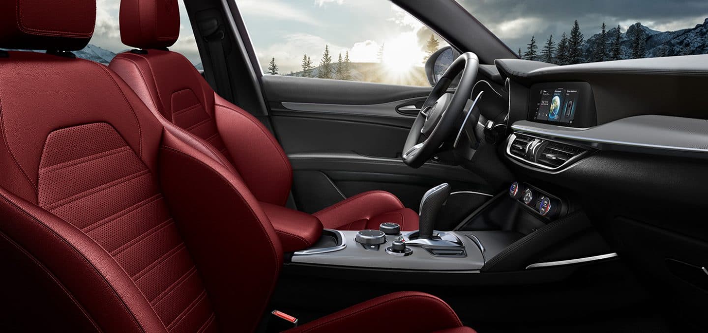 Display The red leather-trimmed front seats and center console in the 2024 Alfa Romeo Stelvio TBD.