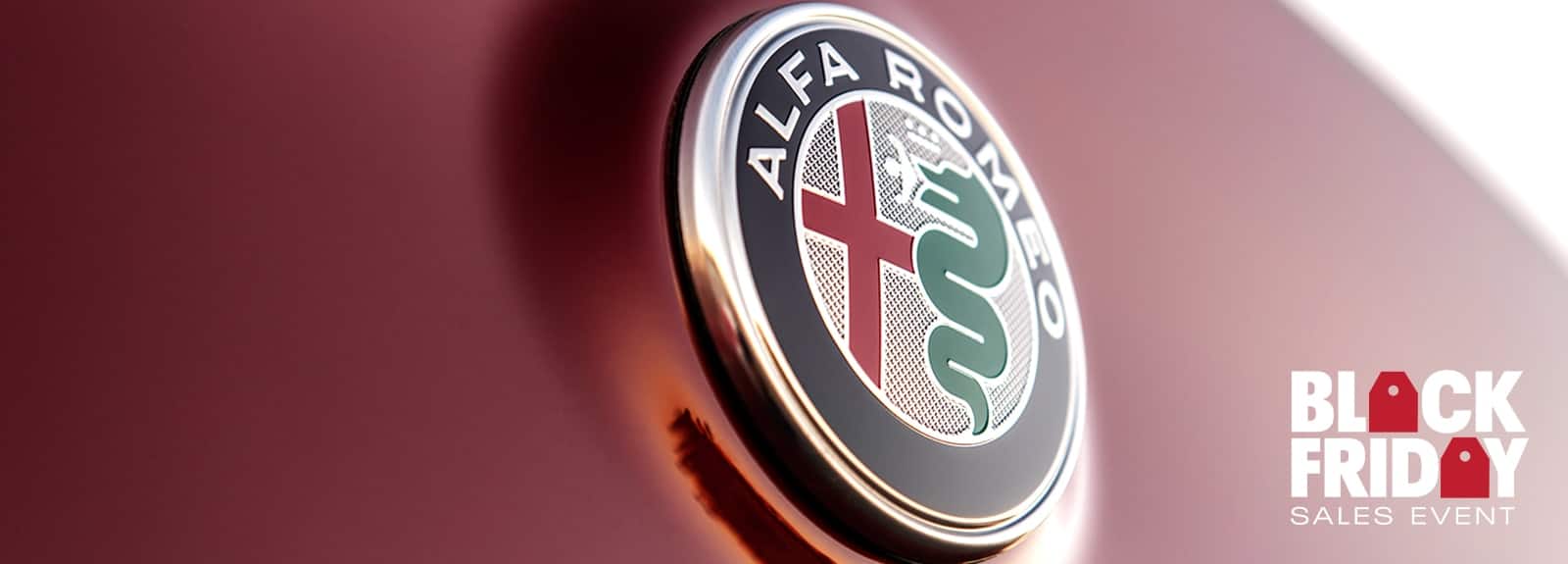 A close-up of the Alfa Romeo badge. Black Friday Sales Event logo.